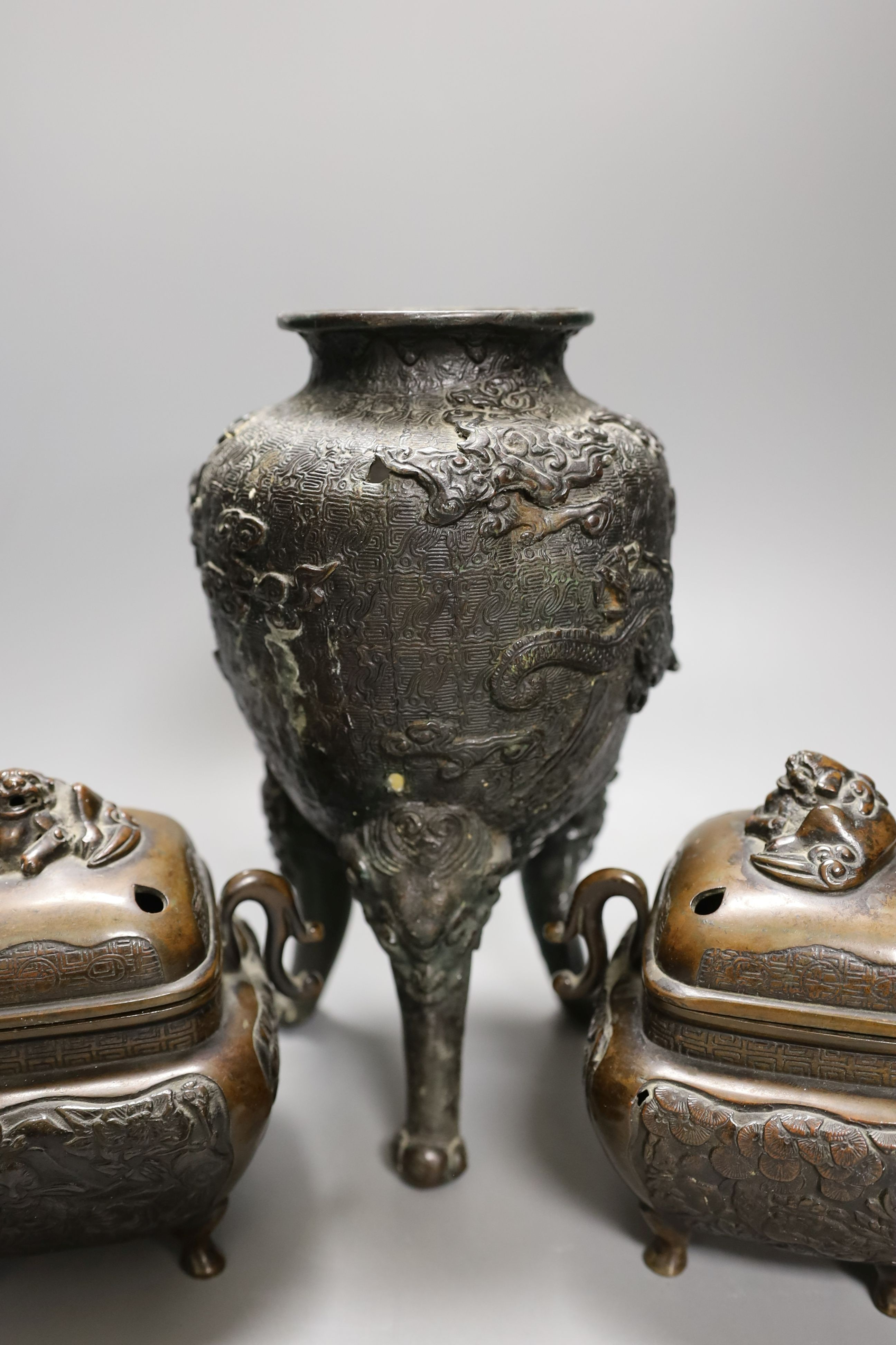 A pair of Japanese bronze censers and covers and a Japanese bronze tripod censer, 23cm tall, (3)